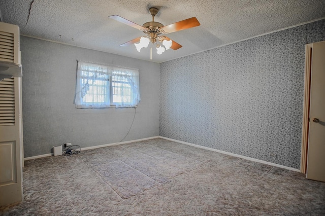 empty room featuring ceiling fan and a textured ceiling