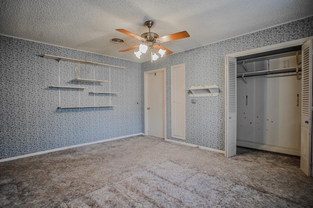 unfurnished bedroom with ceiling fan, carpet flooring, and a textured ceiling