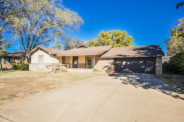 single story home with a garage and a porch