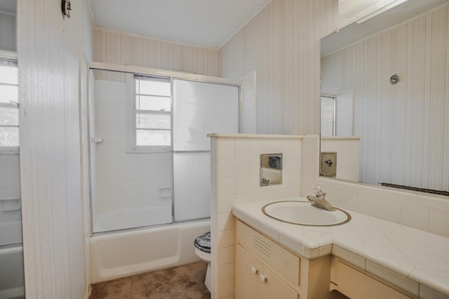 full bathroom with vanity, shower / bath combination with glass door, and toilet