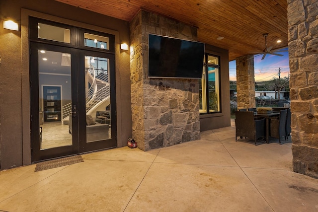 view of exterior entry with french doors and a patio