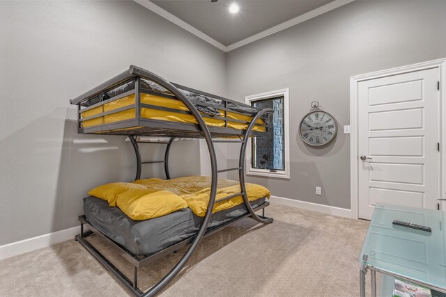 carpeted bedroom with ornamental molding