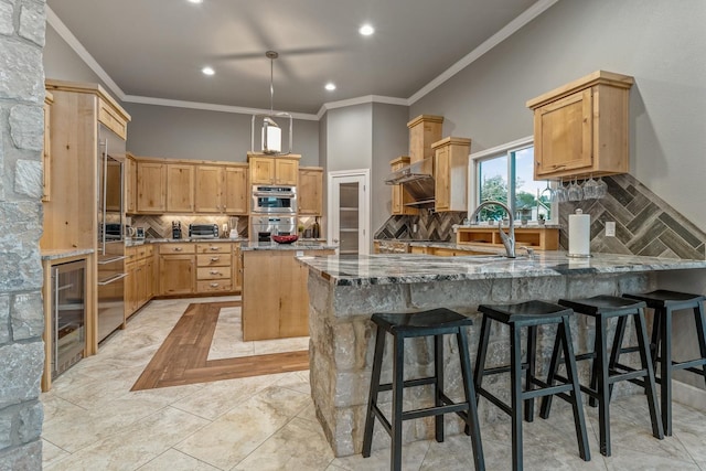 kitchen with a kitchen island, a breakfast bar, light stone counters, and decorative backsplash