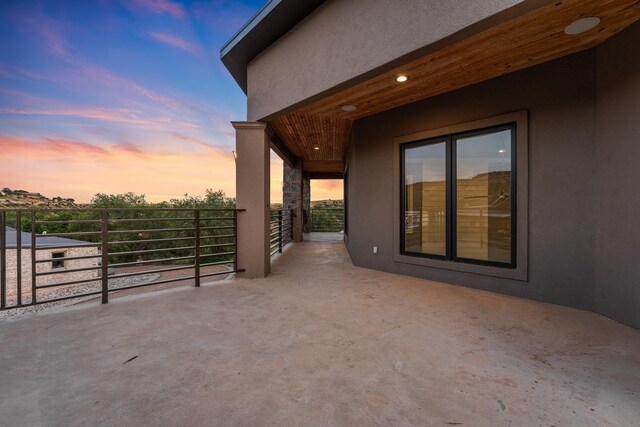 view of patio terrace at dusk