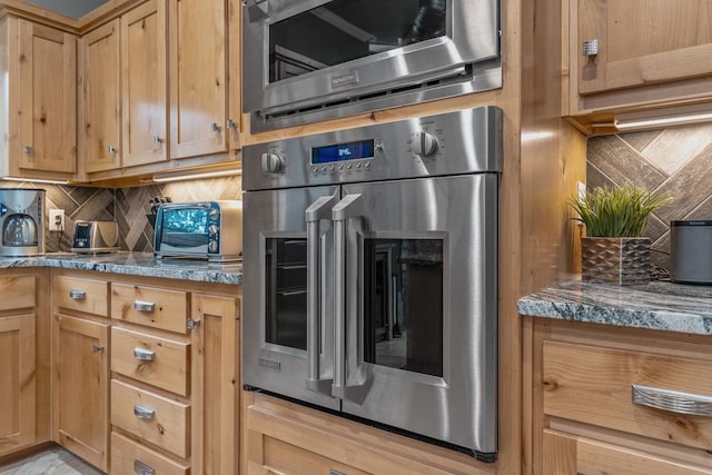 kitchen featuring stainless steel appliances and tasteful backsplash