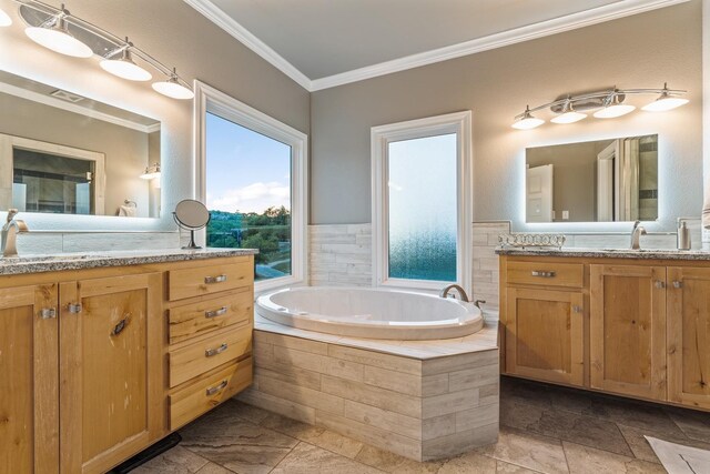 bathroom featuring ornamental molding, vanity, and tiled tub