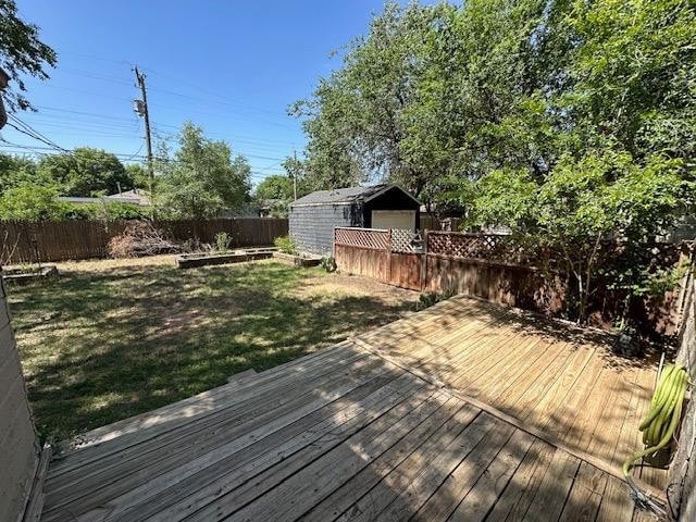 deck featuring a yard and a shed