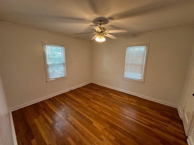 empty room featuring crown molding, ceiling fan, and dark hardwood / wood-style floors