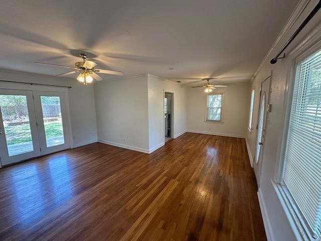 empty room with dark hardwood / wood-style floors and ceiling fan