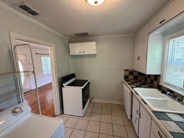 kitchen with washer / clothes dryer, sink, white cabinets, tile counters, and white electric range oven