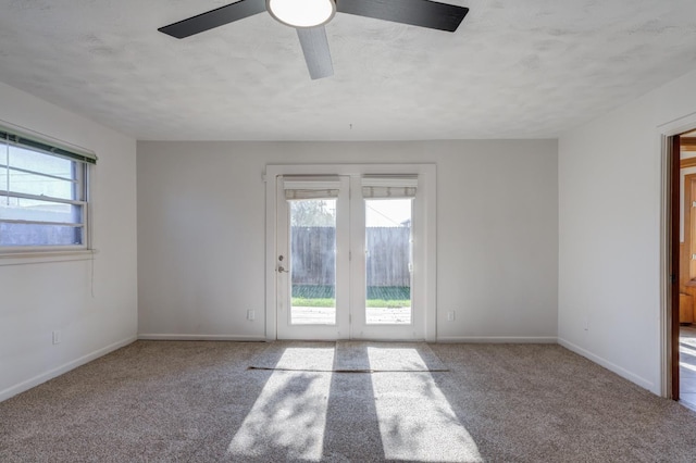 empty room with ceiling fan and carpet flooring