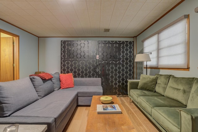 living room featuring ornamental molding and light wood-type flooring