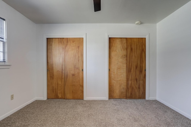 unfurnished bedroom featuring ceiling fan, a closet, and carpet