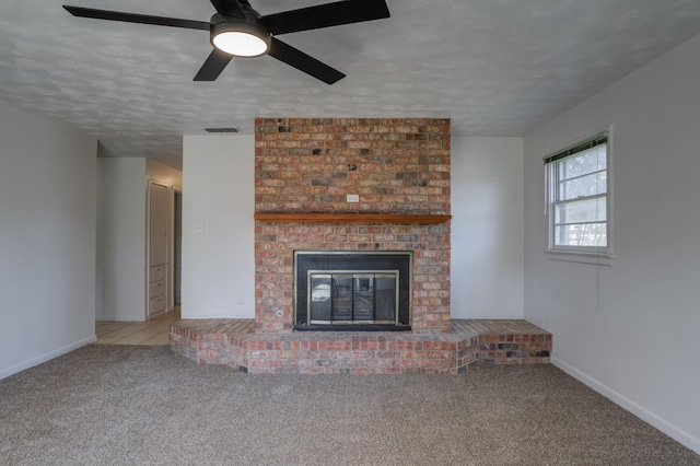 unfurnished living room featuring a brick fireplace, light carpet, and a textured ceiling