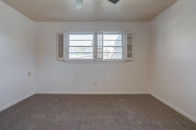 carpeted spare room featuring ceiling fan