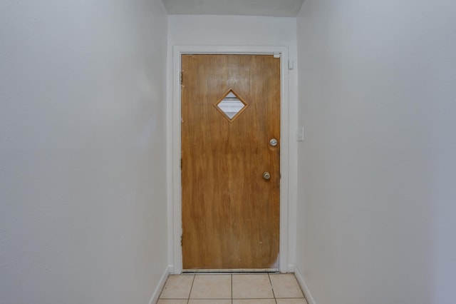 doorway with light tile patterned floors