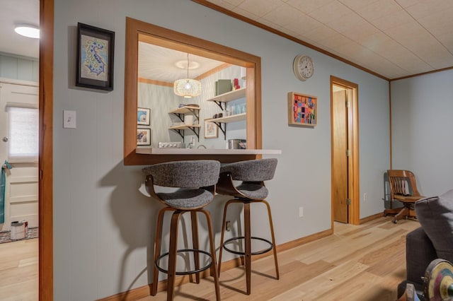 dining area featuring crown molding and light wood-type flooring