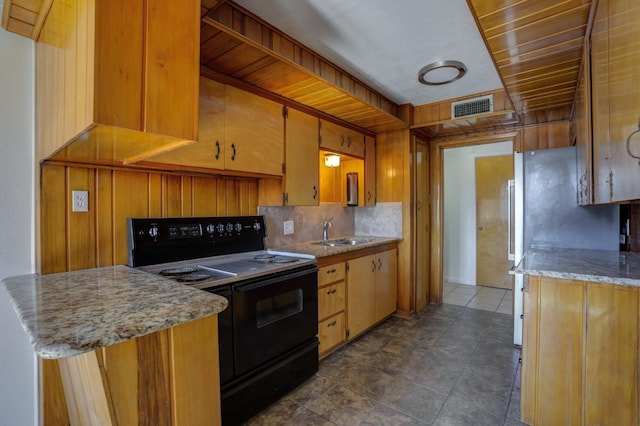 kitchen with black / electric stove, kitchen peninsula, and sink