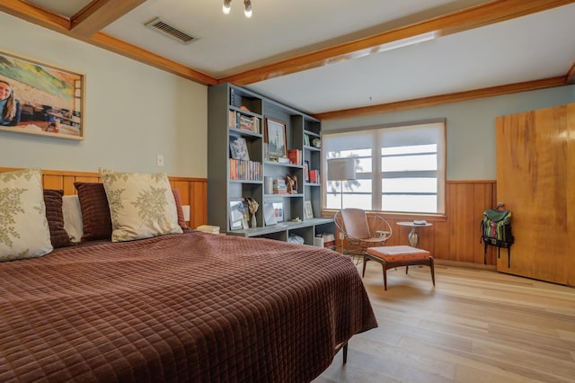 bedroom featuring beam ceiling and light hardwood / wood-style flooring