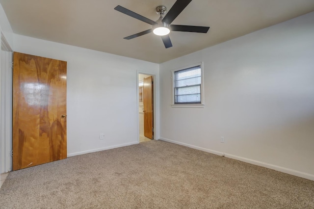 unfurnished bedroom featuring ceiling fan, light colored carpet, and a closet