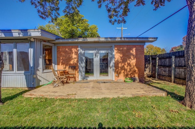 back of house with a yard and a patio