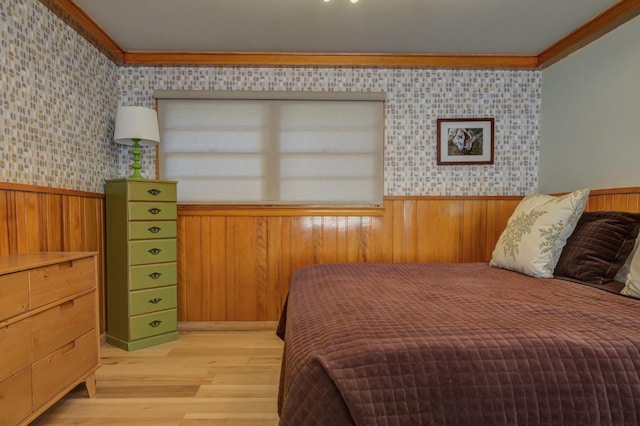 bedroom featuring crown molding and light wood-type flooring