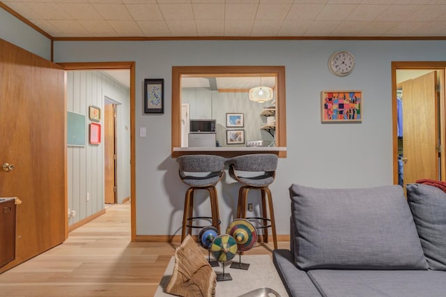 interior space featuring crown molding and light hardwood / wood-style floors