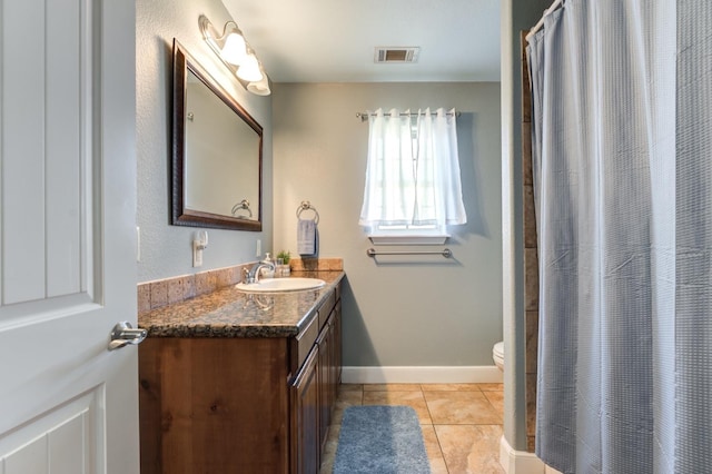 bathroom featuring a shower with shower curtain, vanity, toilet, and tile patterned flooring