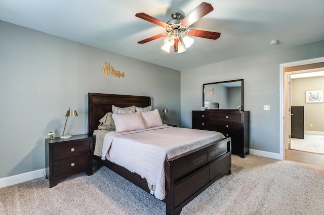 bedroom with ceiling fan and light colored carpet