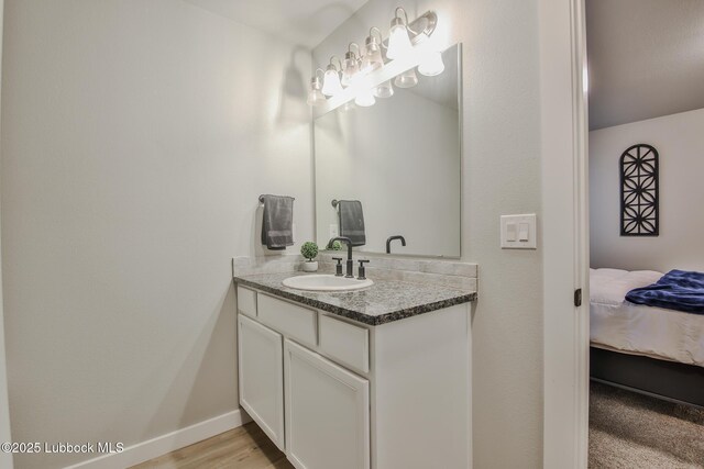 2927 Abbeville Ave, Wolfforth, TX 79382 - bathroom featuring vanity, baseboards, and ensuite bathroom
