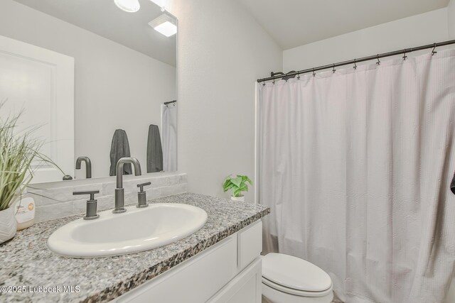 2927 Abbeville Ave, Wolfforth, TX 79382 - bathroom with vanity, toilet, and curtained shower