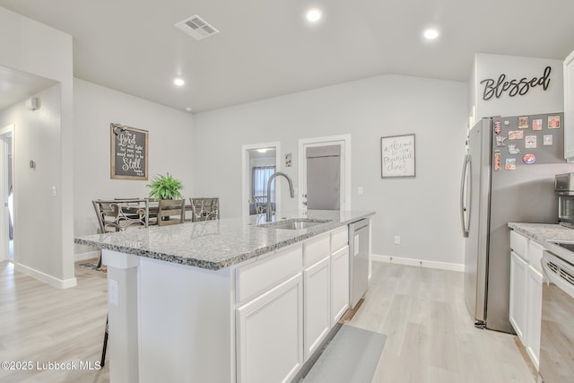 2927 Abbeville Ave, Wolfforth, TX 79382 - kitchen with a sink, dishwasher, light wood-style floors, white cabinetry, and recessed lighting