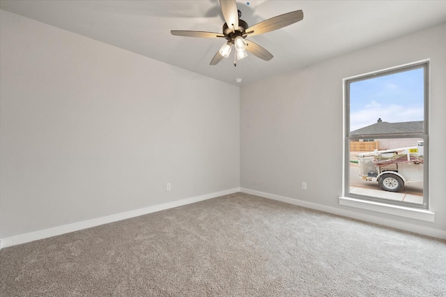 spare room featuring ceiling fan and carpet