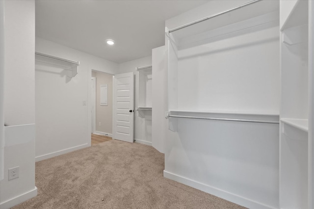 walk in closet featuring carpet flooring