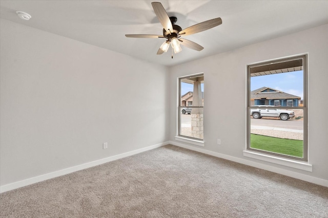 carpeted empty room featuring ceiling fan