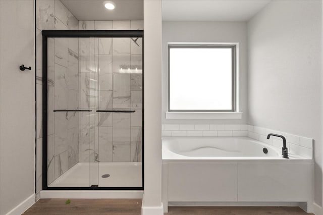 bathroom with shower with separate bathtub and hardwood / wood-style floors