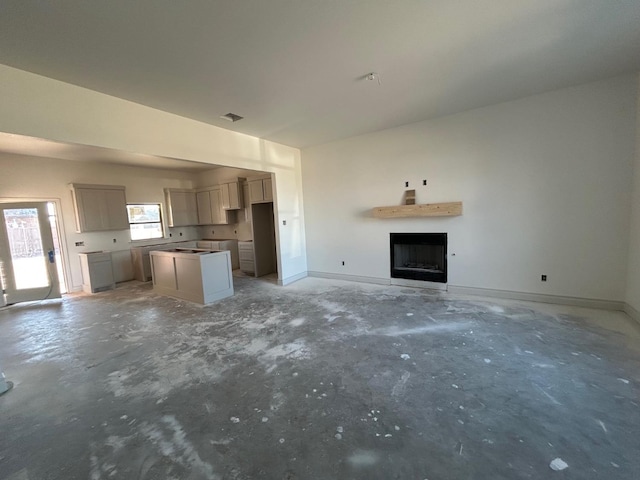 unfurnished living room with concrete flooring