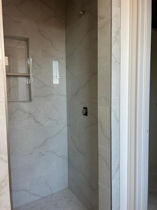 bathroom with tiled shower