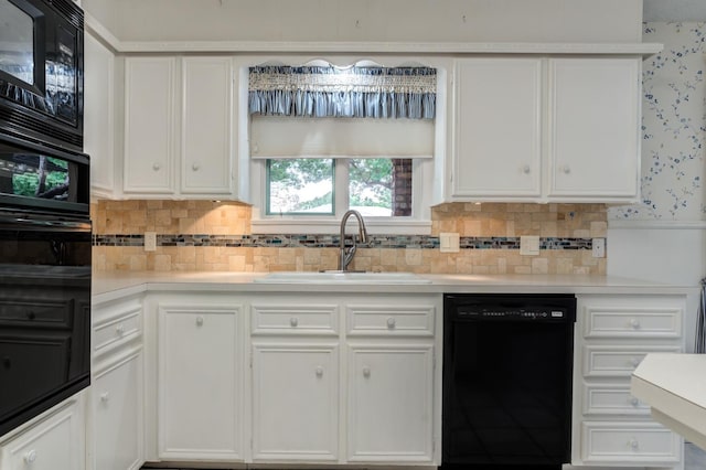 kitchen featuring tasteful backsplash, sink, white cabinets, and black appliances