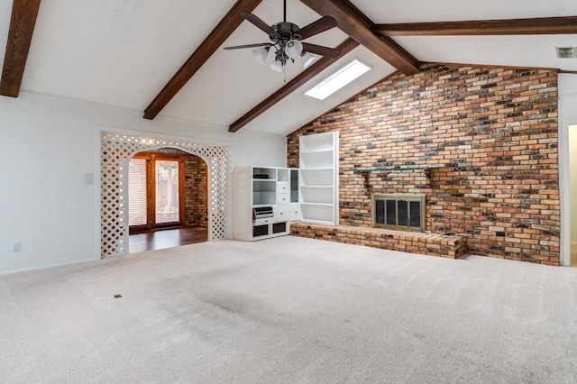 unfurnished living room with carpet floors, beamed ceiling, and ceiling fan