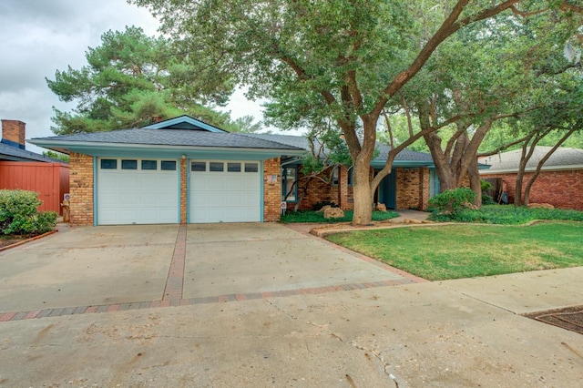 ranch-style home with a garage and a front yard