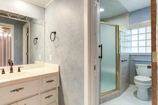 bathroom featuring tile patterned flooring, toilet, vanity, and a shower with shower door