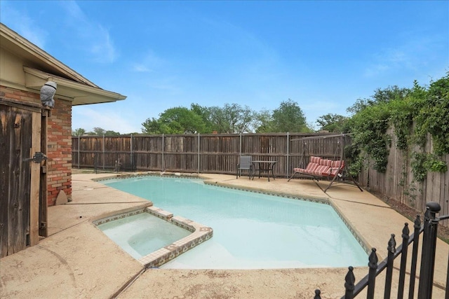 view of swimming pool with a patio area and an in ground hot tub