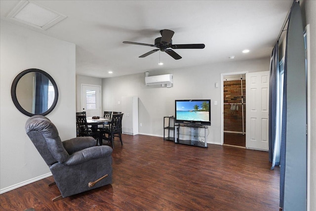 living room featuring an AC wall unit, dark wood-type flooring, and ceiling fan