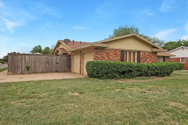 view of home's exterior with a garage and a yard