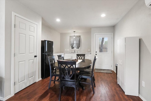 dining space featuring dark hardwood / wood-style flooring and sink