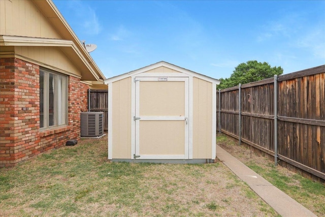 view of outbuilding featuring central AC and a yard