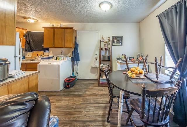 interior space featuring washer / dryer, dark wood-type flooring, white fridge, and a textured ceiling