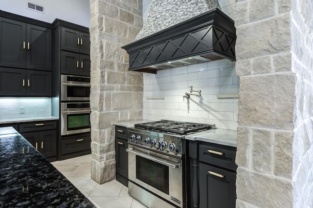 10704 Orlando Ave, Lubbock, TX 79423 - kitchen featuring visible vents, appliances with stainless steel finishes, decorative backsplash, light stone counters, and custom exhaust hood
