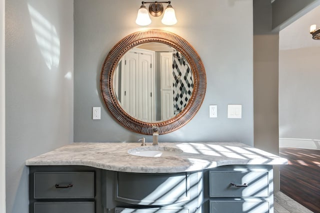 10704 Orlando Ave, Lubbock, TX 79423 - bathroom featuring vanity, baseboards, and wood finished floors